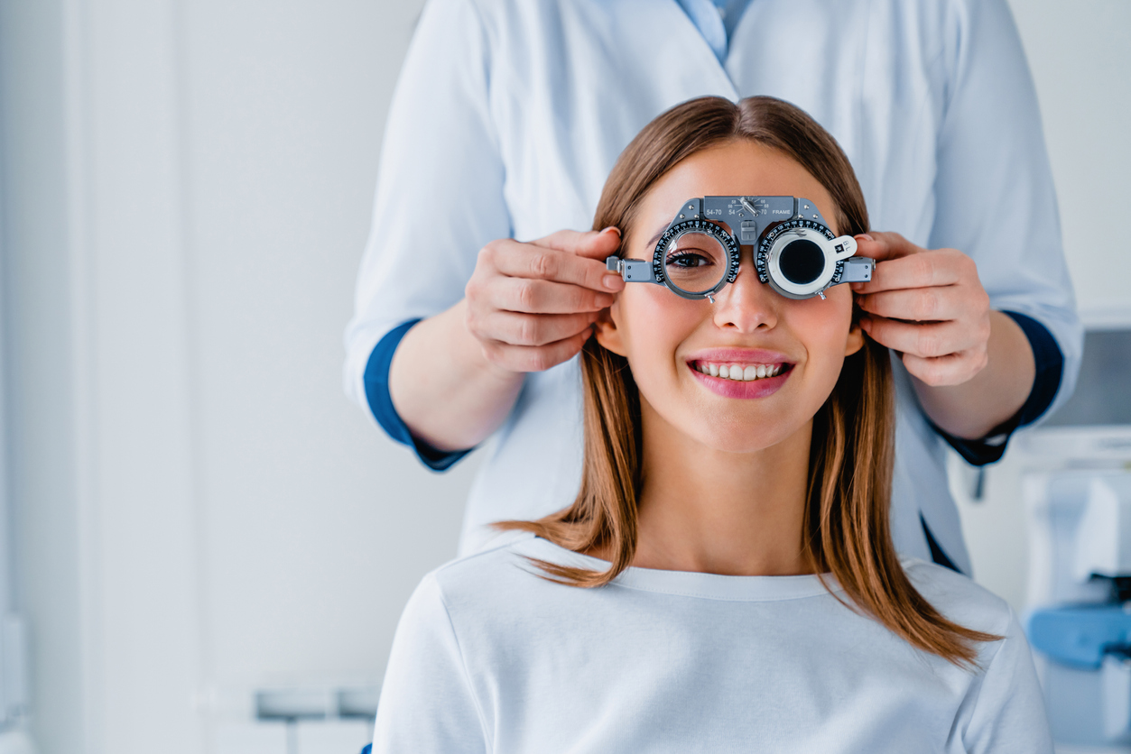 Female patient checking vision in ophthalmological clinic